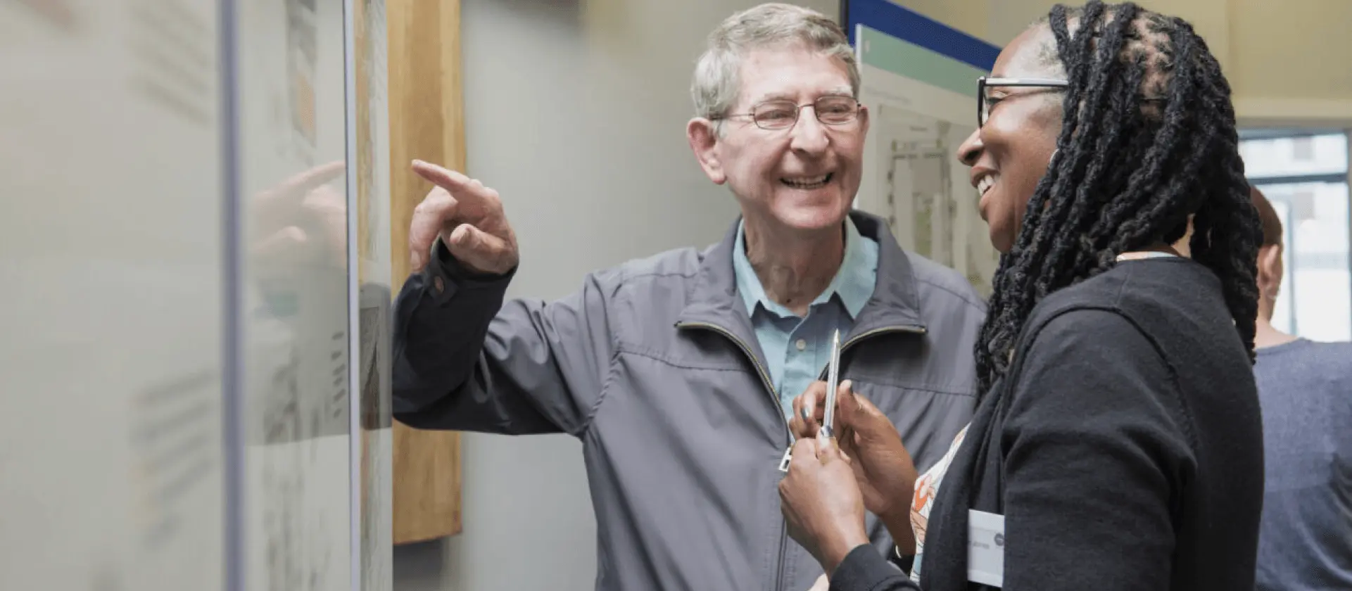 Image of a man and woman talking and smiling.