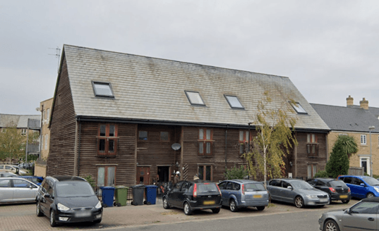 Image of housing block and parked cars