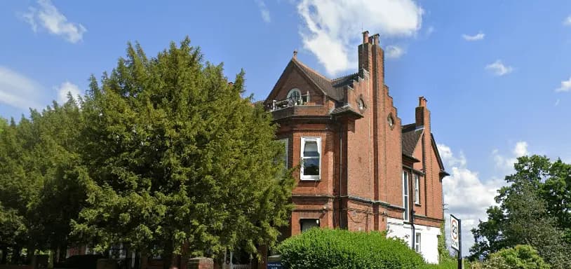 Image showcasing Belmont House building and greenery.