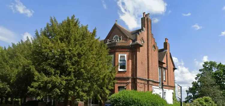 Image showcasing Belmont House building and greenery.